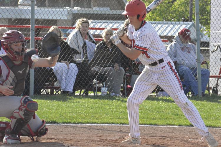 CADEN PAIGE (right) takes a pitch during Richmond’s 5-3 loss to Warrensburg. Trailing 4-0, the Spartans attempt to rally, scoring three runs before Warrensburg tacks up its final run. The Spartans follow Monday’s home defeat by tumbling 11-1 Tuesday at Carrollton, putting them at 4-7 entering a four-game homestand that begins April 21.