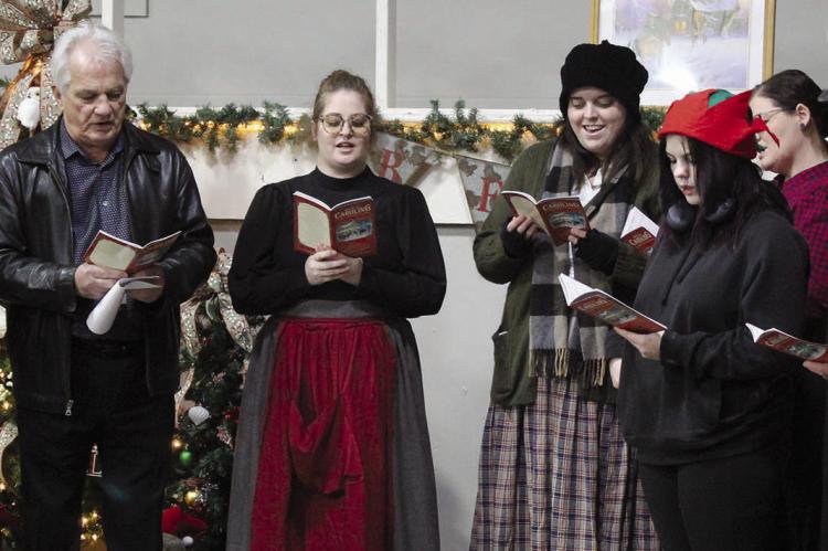 CAST MEMBERS of “Scrooge” sing Christmas carols during the event at the Eagleton Center.