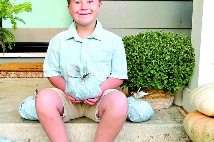GRAYSON GROSSO, 9, shows off a teal pumpkin and the new message for candy-filled holidays. His mother, Sara Grosso, is an advocate for the project. SARA GROSSO | Submitted