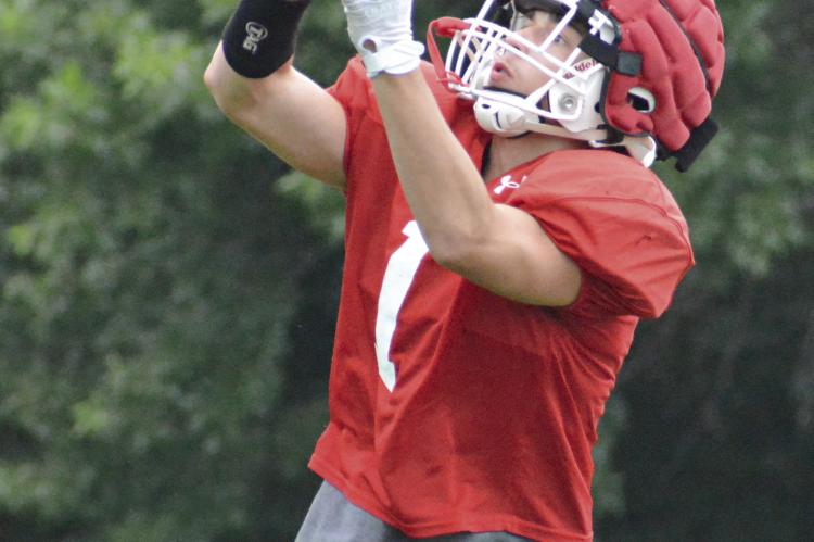 DYSON HENDRIX follows the football into his hands as he and other Richmond skill position players drill over passing routes Tuesday on the Spartans’ practice field. SHAWN RONEY | Staff