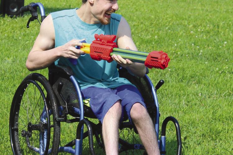 TYLER MEFFORD engages in a water gun fight.