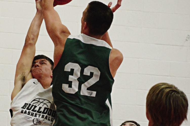 AMID A sea of green jerseys, Hardin-Central’s Kameron Pugh attempts a first-half shot Monday against Polo in the Lawson Middle School gym. SHAWN RONEY | Staff