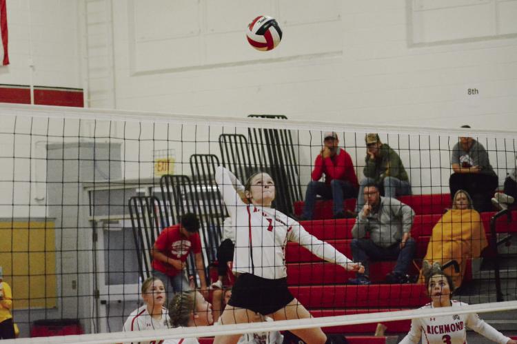 WITH SPECTATORS and her teammates watching, senior Kelly Jaggars leaps high to attempt a kill shot during Richmond’s third-place match with Brookfield Oct. 1 in the Carrollton Tournament. SHAWN RONEY | Staff