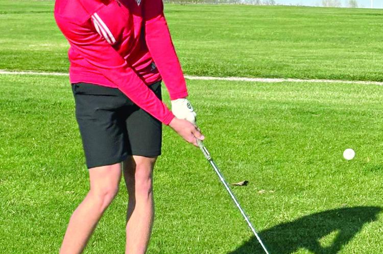 RICHMOND JUNIOR Mattox McCloud attempts a chip shot during a Missouri River Valley Conference-East Division triangular with Lafayette County of Higginsville and Carrollton. BRANDON RITTMILLER | Submitted