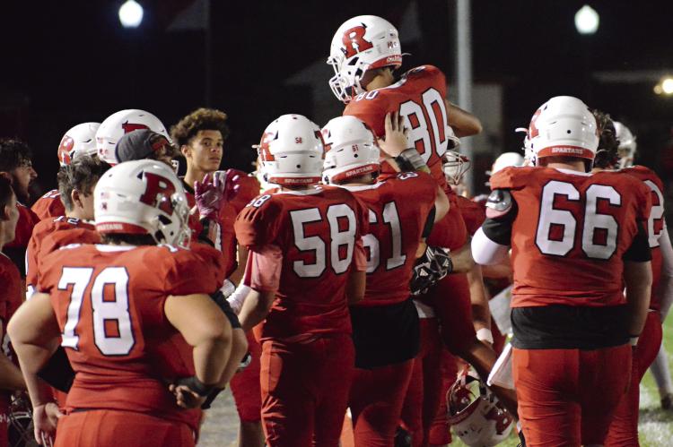 SETH JAMES (No. 80) gets treated as if he has kicked a game-winner shortly after booting an extra point for Richmond during the second half of the Spartans’ 56-7 Week 6 homecoming rout of Carrollton in varsity 11-man football. SHAWN RONEY | Staff