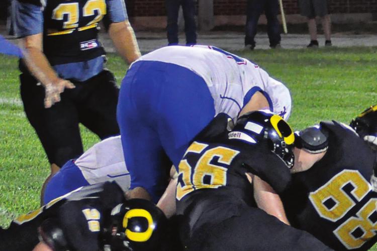 TO THE left of a pile of Bearcats and Saints, Orrick senior Chanler Woods falls on a third-quarter fumble by St. Paul Lutheran of Concordia to help the Bearcats stage a 26-20 comeback victory Aug. 27 at Simmons Field. SHAWN RONEY | Staff