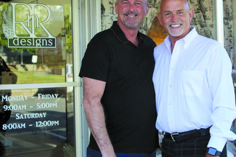 EMBARKING ON A new journey at a later stage in life, Randy Wrisinger (right), stands with his husband, Richard Wilson, on opening day of his new business. SHARON DONAT | Staff