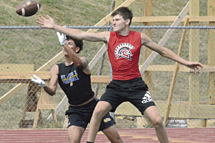 A 200-500 mm lens proves handy in capturing action that’s on the other side of the football field from the camera, as is the case with this photo of a fight for a pass during Richmond’s 7-on-7 scrimmage with St. Pius X of Kansas City in June at Tiger Stadium in Excelsior Springs. SHAWN RONEY | Staff