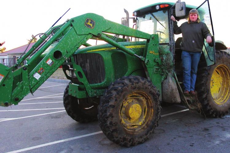 RICHMOND High School FFA student Corbin Calvert, 17, climbs down from the cab of the tractor he drives to school.