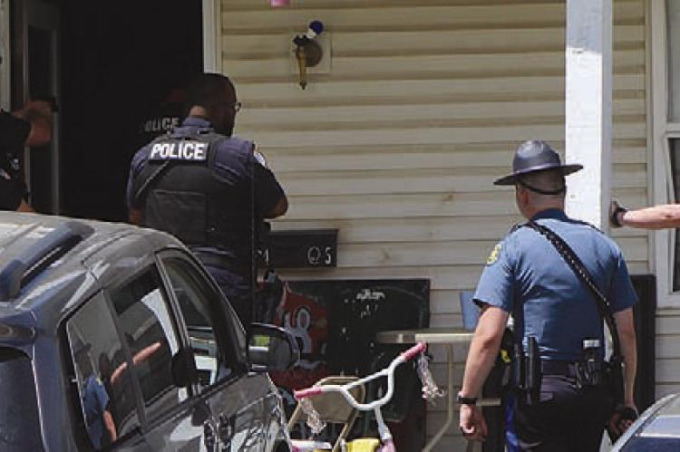 LAW ENFORCEMENT officers secure the perimeter around a Richmond residence during a police standoff. SHARON DONAT | Staff
