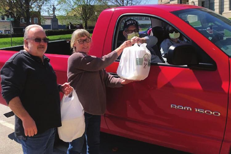 THE RAY COUNTY 911 Emergency Services Board thanks 911 telecommunicators/dispatchers with a meal. From left are board members Robert McClellan and Becky McClellan, who deliver a meal to the day shift telecommunicators/dispatchers. Receiving the meals curbside are Director Kim Davis and Assistant Director Dan Collins.