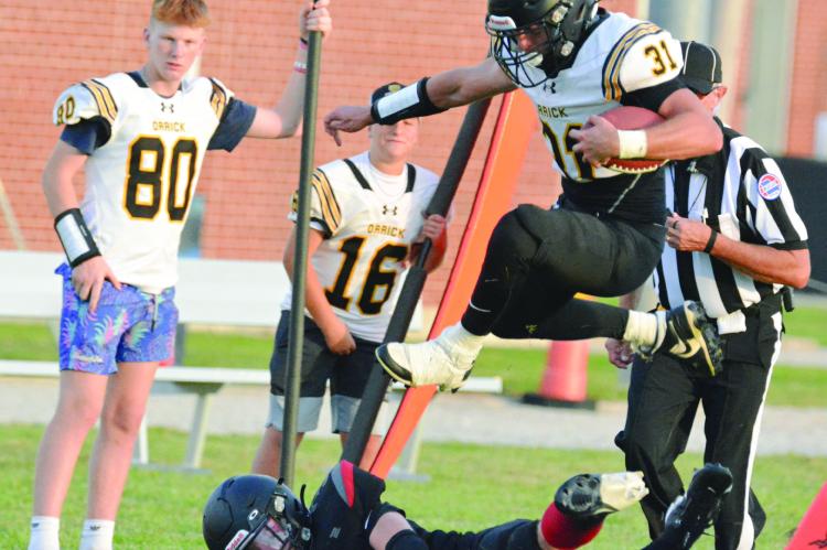 SENIOR JEFF ROHDE, shown hurdling a Northland Christian defensive player during the Bearcats’ Aug. 23 preseason jamboree, is among 30 Orrick High School students out for 8-man football. SHAWN RONEY | Staff