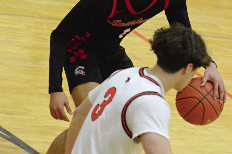 RICHMOND JUNIOR Brice Dome dribbles near the top of the key, with Oak Grove senior Maddox Carillo nearby.