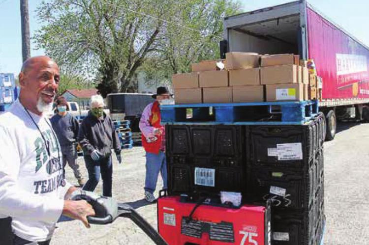 A DRIVER for the Harvesters Community Food Network in Kansas City, Frank Gray, unloads food from the trailer onto the lot of the Salvation Army Family Store in Richmond. J.C. VENTIMIGLIA | Staff