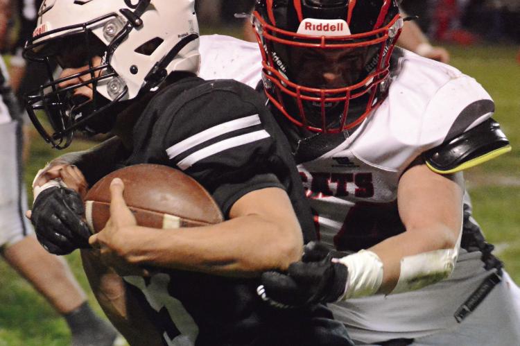 WITH THE FOOTBALL ffirmly tucked against his body, Brody Fifer fights for yardage as he carries for Norborne Hardin-Central in Week 8 varsity action at Hardin-Central. SHAWN RONEY | Staff