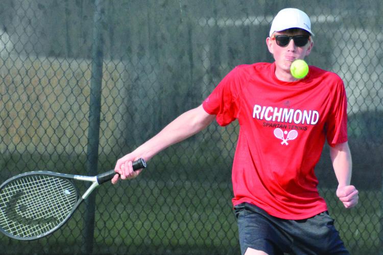 SENIOR DREW ISAACSON looks to hit a return forehand shot Tuesday at Higginsville. SHAWN RONEY | Staff