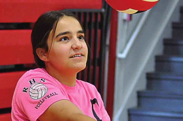 NEW RICHMOND varsity volleyball coach Crystal Turner is a hit with Sarah Brungardt, who practices her bumping. SHAWN RONEY | Staff