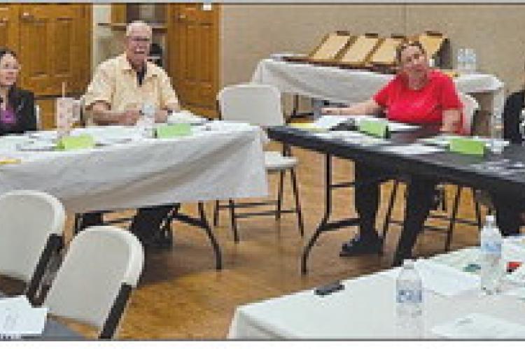 RAY COUNTY COALITION members discuss supply collection, volunteer needs and event logistics for the upcoming back-toschool resource fair. MIRANDA JAMISON | Staff