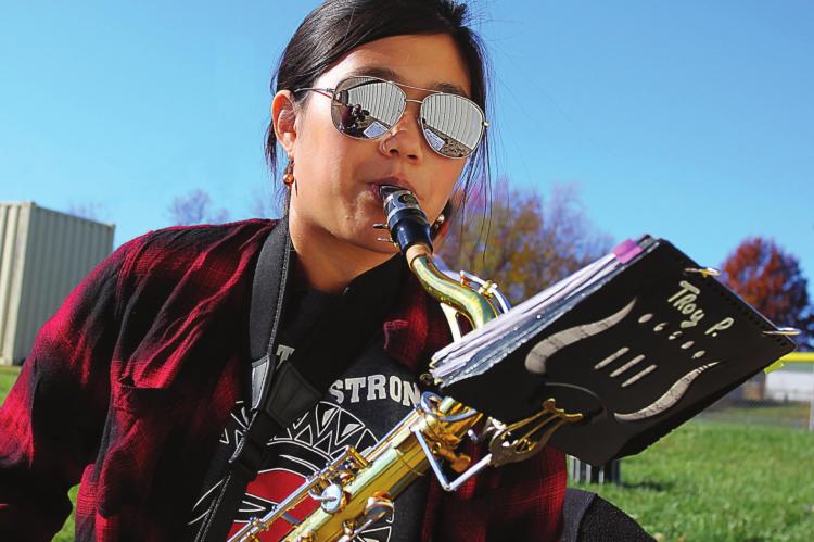 FOR THE VETERANS DAY performance at the Veterans Building, sophomore Aspen Erskine plays the tenor sax. She says getting back to class to work with each other will help band members improve. J.C. VENTIMIGLIA | Staff