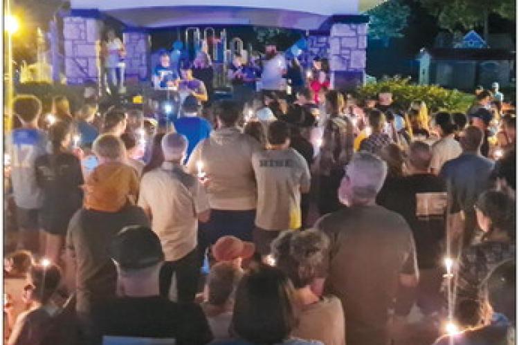 THE LAWSON community holds their candles, lit in remembrance of the student who lost their life and prays for the recovery of the student who was injured. MIRANDA JAMISON | Staff