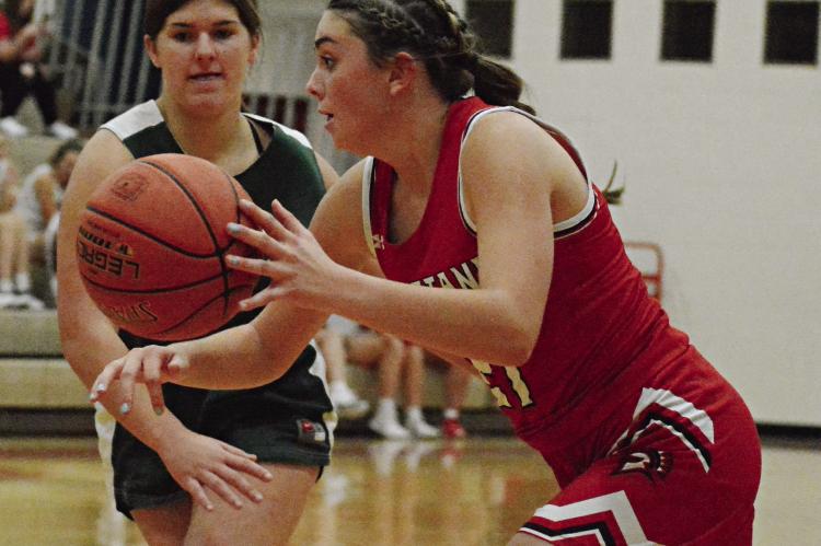 SOPHOMORE EMMA HASH dribbles left during Richmond’s Nov. 14 preseason jamboree scrimmage with Polo, hosted by Lawson, in the Lawson High School gym. SHAWN RONEY | Staff