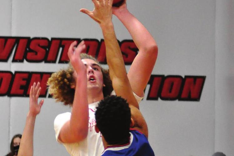 RICHMOND SOPHOMORE Jack Gogue rises above the crowd of Lexington defenders.