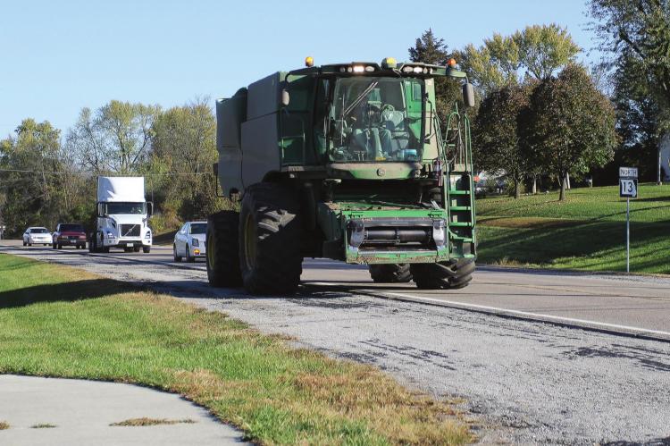 MUCH OF THE HARVEST is in, but work remains. Grain must be hauled along roads throughout the area. Along Highway 13, vehicles move slowly in a line behind farm equipment. The Missouri Coalition for Roadway Safety reminds drivers to be aware of slow-moving combines and other farm equipment. J.C. VENTIMIGLIA | Staff