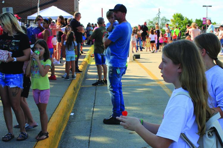Bella Seak plays darts at one of the booths during last year’s Back-to-School Bash at Richmond High School. SOPHIA BALES | Staff