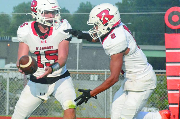 THE KEY for Richmond to win its season opener Friday against visiting Harrisonville is to stay focused, according to junior Cyrus Jackson (No. 8), shown taking a handoff Aug. 19 from Jacob Lieberknecht at Spartan Stadium. SHAWN RONEY | Staff