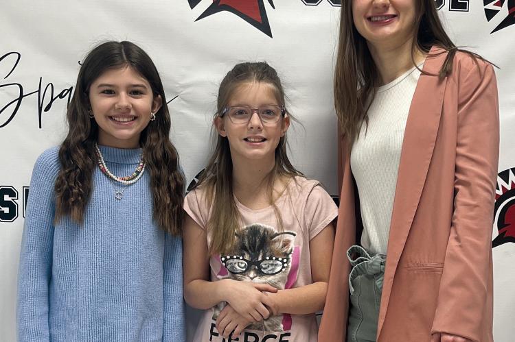 Submitted SUNRISE ELEMENTARY STUDENTS Baylee Crispen and Harper Hockemeier were excited to participate in the All-State Children’s Choir. Shown with the girls is music teacher Ms. Kaelyn Rich.