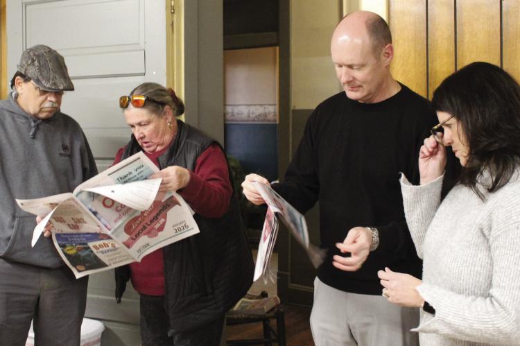 RESIDENT DARROLL RUARK (from left), Chamber Director Jayne Taylor, Richmond School District Superintendent Dr. Bryan Copple and his wife, Rhonda, read the Town and Country Leader’s Love Local Legends section highlighting nominees and winners during the recognition ceremony. MIRANDA JAMISON | Staff