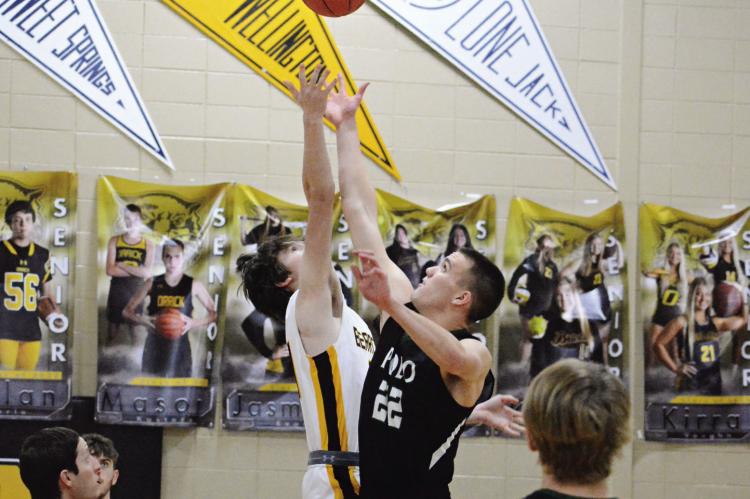 JONATHON HARRIS and Polo junior Hunter McGee leap for the opening tipoff.