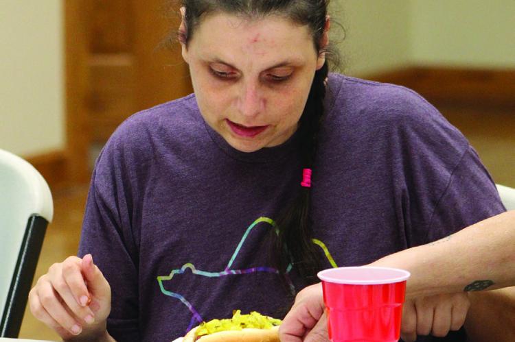 CONSTANCE ARNOLD samples a hot dog topped with zucchini relish. SHARON DONAT | Staff