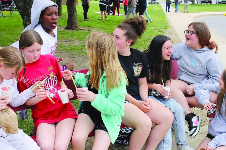 PEYTON FISK (from left), Adelia Desmond, Savion Webb, Autumn Stevens, Olivia McCroskie, Brayliegh Martinez, Maci Torrey and Leighton Hoyle chat amongst themselves as they enjoy the middle school festivities for the MAP testing celebration. SOPHIA BALES | Staff