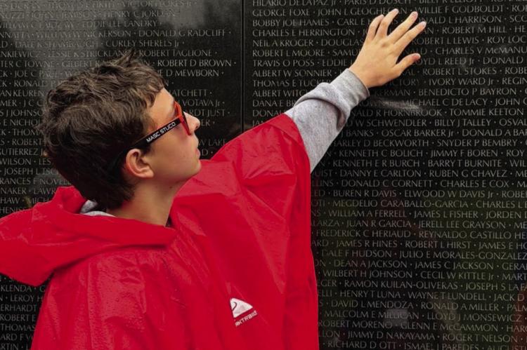GABRIEL REED SEARCHES for the name of a relative on the Vietnam Veterans Memorial during Richmond Middle School’s 37th annual Washington, D.C., trip. Story on page 7. Submitted