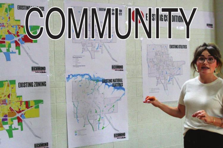DURING THE CHARRETTE, Olsson Studio project planner Taylor Plummer discusses maps used to see where the city is and assist in where it might go. J.C. VENTIMIGLIA | Staff