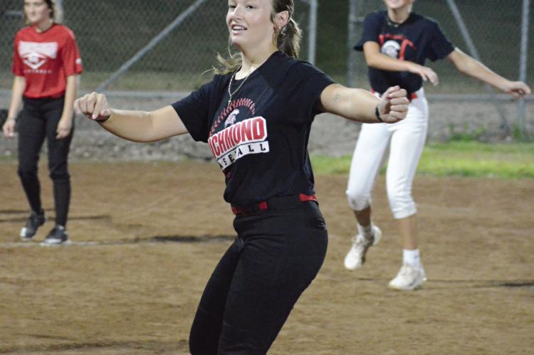 KYNLEE LOPEZ (center) helps to lead the Richmond varsity softball team in exercises shortly after midnight Monday in the ballclub’s first practice of the fall sports season. SHAWN RONEY | Staff