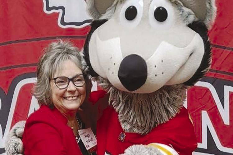 STATE REPRESENTATIVE Peggy McGaugh shows her support of the Kansas City Chiefs by embracing the Kansas City Wolf. Submitted