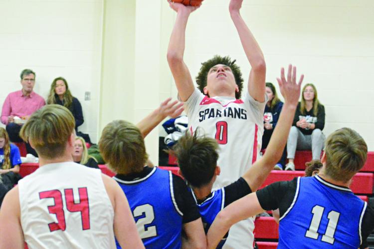RICHMOND SENIOR Gabe Johnson (center) draws a crowd as he attempts a first-half shot. SHAWN RONEY | Staff