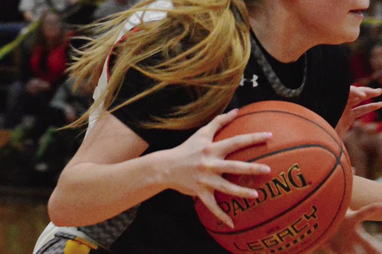 ADDISON CHAPMAN stares intently down the court as she dribbles during Orrick’s Class 1 District 13 Tournament semifinals with Hardin-Central in girls basketball. The 62-38 defeat Feb. 25 at Norborne ended the Orrick girls’ season at 8-20. It also was the final game in an Orrick basketball uniform for Chapman, the lone senior listed on Orrick’s girls varsity roster.