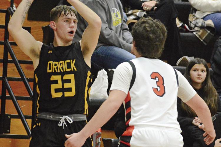 ORRICK JUNIOR Xavior Gaskins (left) looks to pass while guarded by Hardin-Central’s Collin Lyon. SHAWN RONEY | Staff