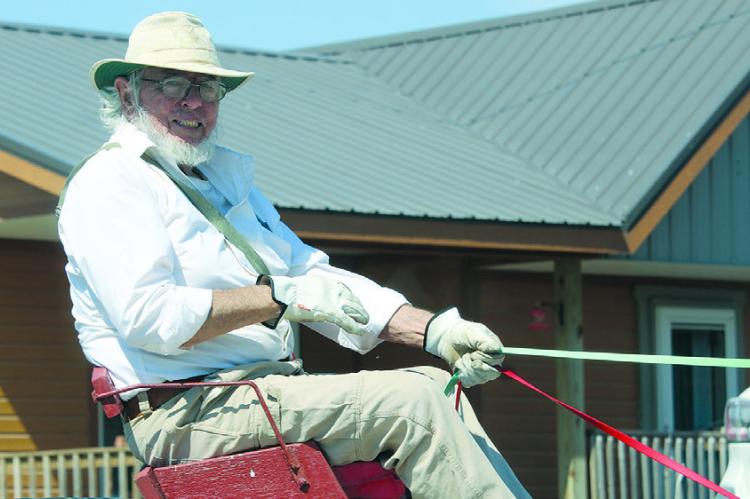 JEFF MCFADDEN leads his donkeys while passing environmental knowledge on to the next generation. MIRANDA JAMISON | Staff