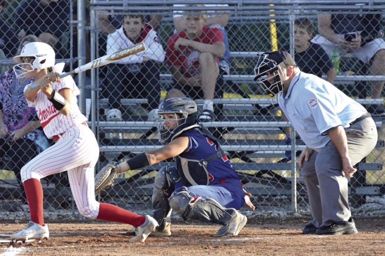 MAYA GRIFFIN (left) swings at a pitch during Richmond’s recent varsity softball meeting with visiting Lexington at Southview Park. SHAWN RONEY | Staff