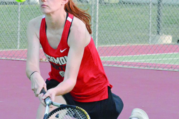 TALYN TEEGARDEN hustles to attempt to return a shot during her singles match with Lexington’s Emma McMillan Tuesday at Maurice Roberts Park. SHAWN RONEY | Staff