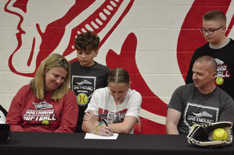 RICHMOND SENIOR Sydney Appleberry signs her letter of intent March 15 in her high school gym to play softball for and study at Moberly Area Community College as members of her family watch. Also pictured are (from left), front row, parents Cody and Brian Appleberry; second row, brothers Bryson and Hunter Appleberry. SHAWN RONEY | Staff