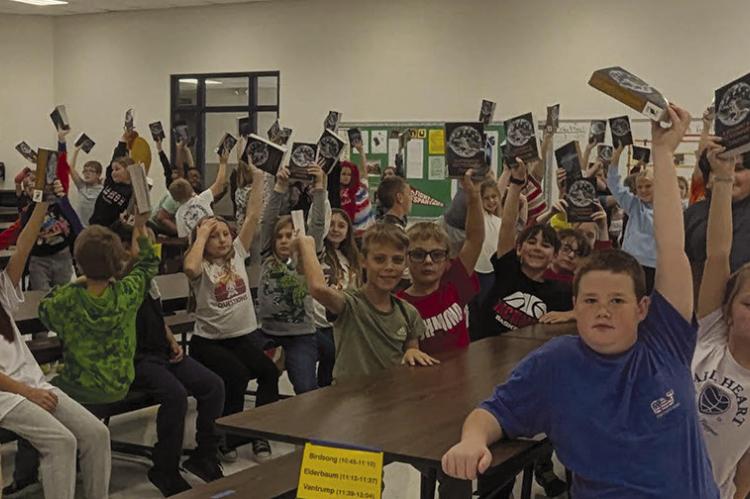 KIWANIAN BILL DOOLEY celebrates with Richmond third-graders after the Kiwanis Club presented dictionaries to the students. Submitted