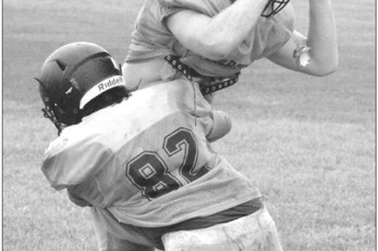 GABRIEL GRAVES (No. 82) and Tucker Greer work on tackling drills Monday on the Orrick practice field. SHAWN RONEY | Staff