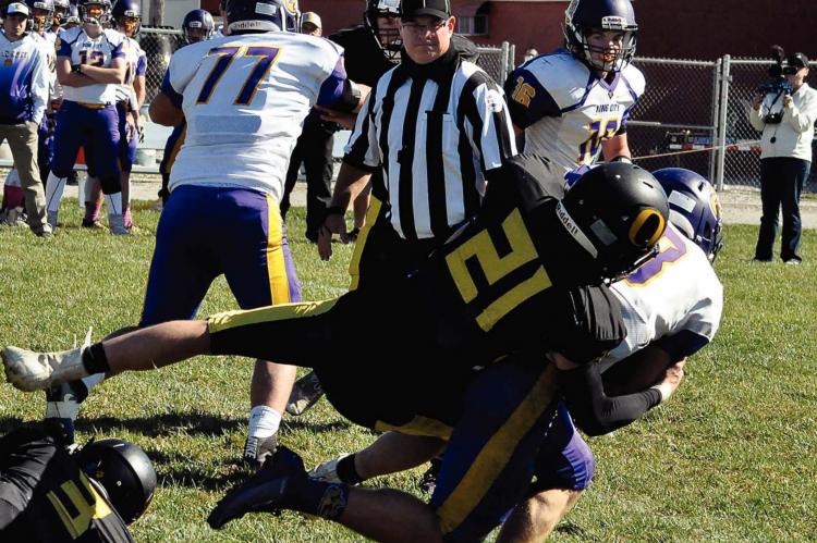 ORRICK SENIOR Ethan Wilson, No. 21, and his fellow Bearcats find King City/Union Star running back Parker Muff to be a load to bring down in the Bearcats’ District 3 loss. SHAWN RONEY | Staff