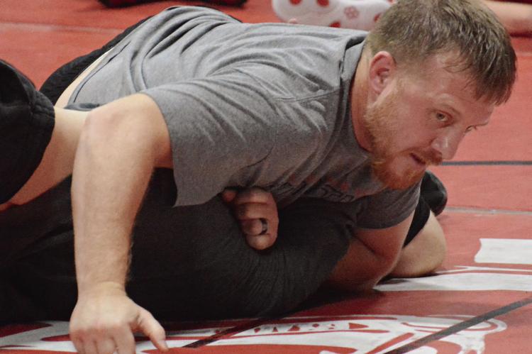 RICHMOND COACH Cody Hogan demonstrates some wrestling techniques.