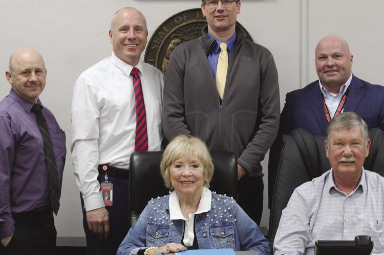 RAY COUNTY COMMISSIONERS and school district leaders review and sign agreements establishing county funding for D.A.R.E. and drug prevention education in local schools. MIRANDA JAMISON | Staff